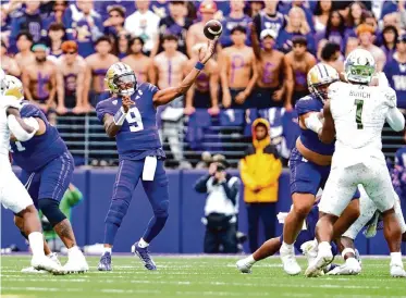  ?? Lindsey Wasson/Associated Press ?? Washington quarterbac­k Michael Penix Jr. (9) completed 22 of 37 pass attempts for 302 yards and four touchdowns as the Huskies rallied for a victory over Oregon on Saturday in Seattle.