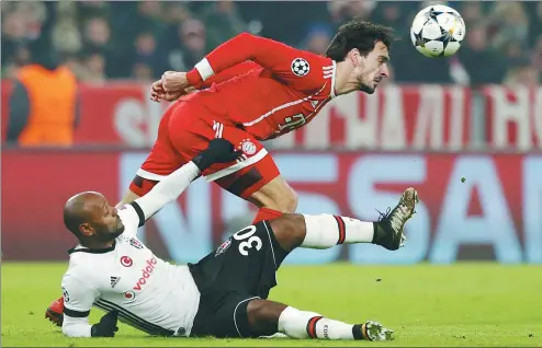  ?? MICHAELA REHLE / REUTERS ?? Bayern Munich defender Mats Hummels beats Besiktas striker Vagner Love to the ball during Tuesday’s Champions League last-16 first-leg match at Munich’s Allianz Arena on Tuesday. Bayern won 5-0.