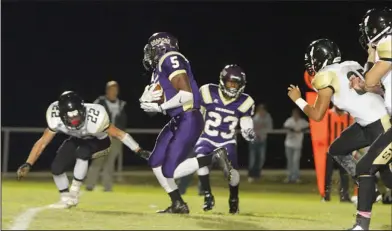  ?? Terrance Armstard/News-Times ?? On the move: Junction City running back Hishmma Taylor carries the ball during the Dragons' playoff game against Manila last season. A senior, Taylor will be counted on to be a major part of Junction City's offense this season. The Dragons will open...