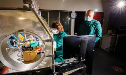  ?? Photograph: Sam Frost/The Guardian ?? Dr Allen Haddrell and Henry Oswin (seated) check the Celebs equipment ahead of the study, due to begin on Monday.