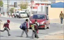  ?? Picture: Armand Hough/African News Agency (ANA) ?? DANGER: Children cross a road in Delft, where there are no road signs or traffic lights.