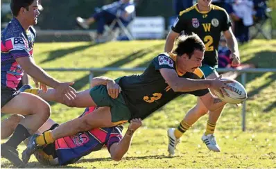  ??  ?? TRY TIME: Braydon Wilson dives over for a try for Wattles against Highfields. PHOTO: KEVIN FARMER