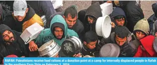  ?? ?? RAFAH: Palestinia­ns receive food rations at a donation point at a camp for internally displaced people in Rafah in the southern Gaza Strip on February 2, 2024.