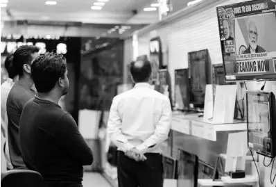  ?? AP ?? Indians watch Prime Minister Narendra Modi address the nation in a televised speech at an electronic­s store in Jammu, India, on Thursday, August 8, 2019. Modi said a federally ruled Indian portion of Kashmir would help end decades-old separatism incited by archrival Pakistan. Describing changes in Kashmir as historic, Modi assured Kashmiri people that the situation in the region would soon become normal.