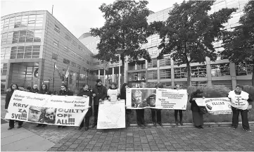  ??  ?? People, including victims, protest in front of the Internatio­nal Criminal Tribunal for the former Yugoslavia (ICTY) in The Hague, prior to the verdict in the genocide trial of Mladic. — AFP photo