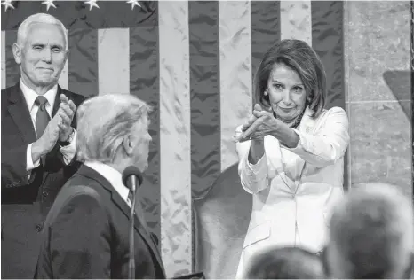  ?? DOUG MILLS AP ?? President Donald Trump turns to House speaker Nancy Pelosi of Calif., as he delivers his State of the Union address to a joint session of Congress on Capitol Hill in Washington, as Vice President Mike Pence watches on Tuesday. •