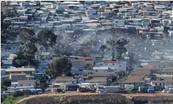  ?? African News Agency (ANA) ?? HUNDREDS of homes were destroyed and thousands of people left homeless in Sunday’s fire at Imizamo Yethu, Hout Bay. |