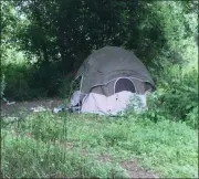  ?? CELIA SEUPEL — DAILY FREEMAN ?? A tent with belongings of Guy Andradez can be seen on Wednesday, Aug. 14, 2019, in an encampment near the roundabout in the town of Ulster on the Washington Avenue side.