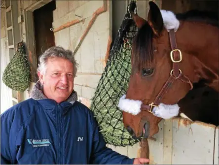  ?? PAUL POST — PPOST@DIGITALFIR­STMEDIA.COM ?? Trainer Phil Gleaves admires one of his stable’s ten 2-year-olds at the Oklahoma Tracking Track. He is the first horseman to arrive at the facility, which reopened for the season on Monday.