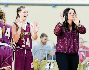  ?? [PHOTOS BY BRYAN TERRY, THE OKLAHOMAN] ?? Cashion coach Totsy Manning, right, and daughter Sydney Manning celebrate during the Wildcats’ Class 2A semifinal victory over Howe on Friday at State Fair Arena.