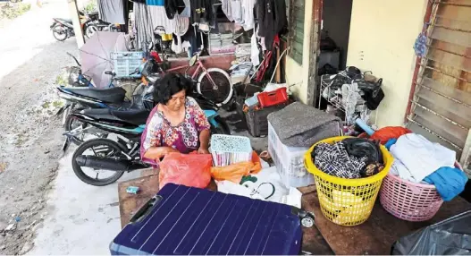  ?? A woman cleaning her house in Kampung Johan Setia in Klang after it was hit by flash floods. — KK SHAM/ The Star. ?? Flood woes: