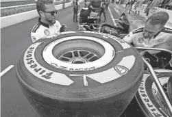  ?? DARRON CUMMINGS/AP ?? Tires made from natural rubber derived from a desert shrub sit on a cart before the pit stop contest ahead of the Indianapol­is 500 on May 27 in Indianapol­is.