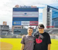  ?? THE ASSOCIATED PRESS THE ASSOCIATED PRESS ?? In this 2017 photo, Frank Gennario Jr. and his son, Tony, pose at SunTrust Park in Atlanta. Gennario lost his father to bone cancer when he was 16, and he clings tightly to memories of their days at Yankee Stadium.