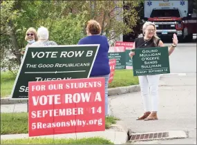 ?? Arnold Gold / Hearst Connecticu­t Media ?? Campaign volunteer Danielle Butti, right, waves to voters as they arrive at the Guilford Fire Department to vote in the Republican primary for the Board of Education in Guilford on Sept. 14.
