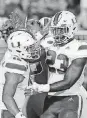  ?? [AP PHOTO] ?? Miami quarterbac­k Malik Rosier, left, is congratula­ted by Christophe­r Herndon IV after a touchdown against Duke.