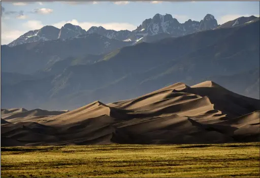  ?? HELEN H. RICHARDSON — THE DENVER POST ?? The Great Sand Dunes are lit by the setting sun near Mosca, on June 19, 2019.