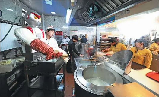  ?? YANG HUAFENG / CHINA NEWS SERVICE ?? A robot makes noodles in a restaurant in Changsha, the capital of Hunan province. Chinese businesses are predicting a boom in the use of robots in the country.