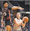  ?? Jessica Hill / Associated Press ?? UConn’s Kyla Irwin, right, looks to shoot against Virginia on Tuesday in Hartford.