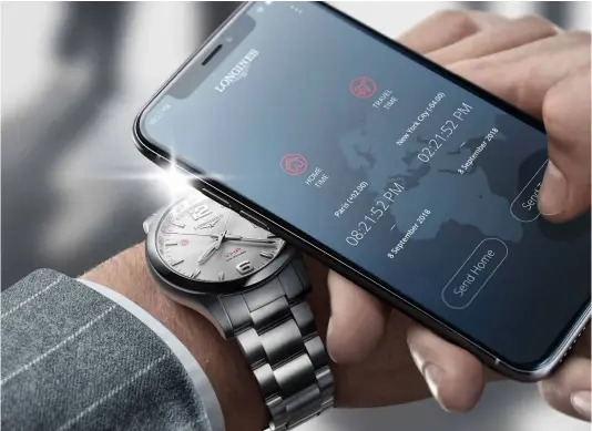  ??  ?? using Longines’s mobile app to set home and travel time on the conquest V.H.P. flash setting