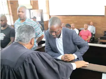  ?? MOTSHWARI MOFOKENG ?? HARRY Gwala executive mayor Mluleki Ndobe consults with lawyer Larry Seethal before appearing in the Umzimkhulu Magistrate’s Court along with other accused people. They have been arrested in connection with the murder of Sindiso Magaqa. |African News Agency (ANA)