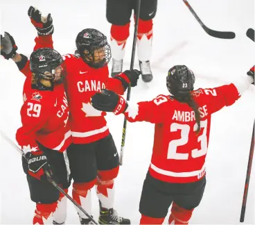  ??  ?? Canada celebrates after Mélodie Daoust scores on Switzerlan­d in semifinal action.