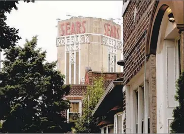  ?? Bebeto Matthews Associated Press ?? SEARS SIGNAGE in Brooklyn, N.Y. The company faces a crucial debt maturity next week. The future of its 89,000 employees — down from 246,000 in 2013 — and the Kenmore appliance brand remain up in the air.