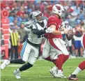  ?? MICHAEL CHOW/THE REPUBLIC ?? Cardinals quarterbac­k Colt McCoy is sacked by Panthers linebacker Haason Reddick on Sunday. McCoy fumbled on the play.