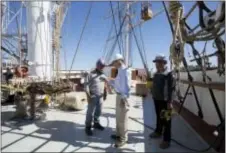  ?? MARK LENNIHAN — THE ASSOCIATED PRESS ?? Steve Kalil, center, president of Caddell Dry Dock, oversees the renovation of the sailing ship Wavertree, Thursday in the Staten Island borough of New York.