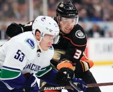  ??  ?? Nick Ritchie, right, signed a three-year deal with the Anaheim Ducks after sitting out the first seven games. He was in much the same situation as the Leafs’ William Nylander, who remains unsigned.