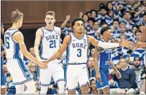  ?? BEN MCKEOWN] ?? Duke's Tre Jones (3) celebrates with teammates after a play during the first half of the team's game against Georgia State. [AP PHOTO/