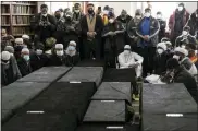  ?? YUKI IWAMURA/ASSOCIATED PRESS ?? Caskets sit on the floor during the funeral service for victims from the apartment building which suffered the city’s deadliest fire in three decades, at the Islamic Cultural Center for the Bronx on Sunday, Jan. 16, 2022, in New York.