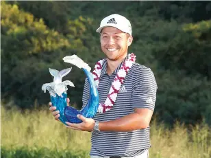  ?? BRIAN SPURLOCK-USA TODAY SPORTS ?? PGA GOLFER Xander Schauffele poses with the trophy after winning the Sentry Tournament of Champions golf tournament at Kapalua Resort — The Plantation Course.