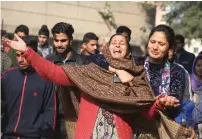  ?? AP ?? Relatives of Garu Singh, 55, who was killed in Pakistani firing and shelling, react in Ranbir Singh Pura district on Saturday. —