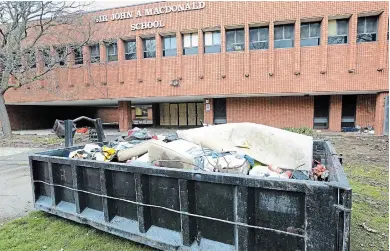  ?? JOHN RENNISON THE HAMILTON SPECTATOR ?? A garbage bin remains after a homeless camp was dismantled Monday in front of the former Sir John A. Macdonald school.