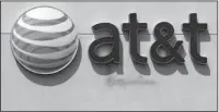  ?? The Associated Press ?? MASSIVE DEAL: An AT&T logo on a store is shown May 14 in Dedham, Mass. On Saturday, several reports citing unnamed sources said the giant phone company is in advanced talks to buy Time Warner, owner of the Warner Bros. movie studio as well as HBO and...