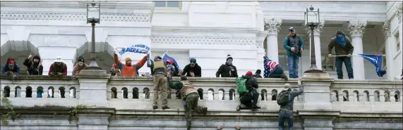  ?? ASSOCIATED PRESS FILE ?? Rioters climb the west wall of the U.S. Capitol in Washington, Jan. 6, 2021.