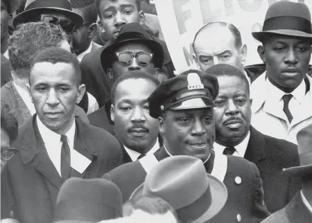  ?? AP FILE PHOTO ?? RALLY IN BOSTON: Dr. Martin Luther King Jr., center, leads a march to Boston Common on April 23, 1965, to protest segregatio­n in schools, jobs and housing.