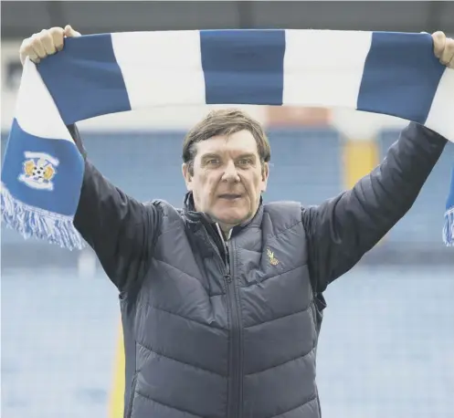  ??  ?? A slimline Tommy Wright raises the scarf of his new club, Kilmarnock, in time-honoured fashion at Rugby Park yesterday.