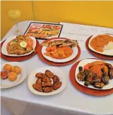  ?? VICTOR HILITSKI/SUN-TIMES ?? TOP ROW (from left): Ginger pineapple drink, yassa with chicken, Senegalese national fish dish, and mafe. ABOVE (from left): stuffed chicken balls, plantains and jerk chicken.