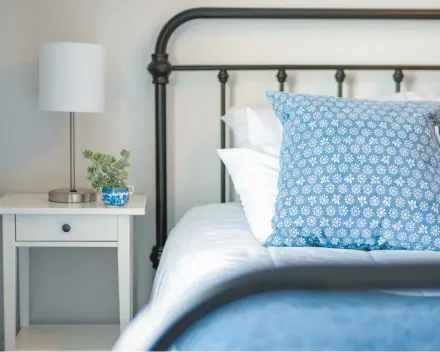  ?? KRISTEN PRAHL/GETTY ?? Consider using a side table instead of a nightstand. They serve the same purpose and often aren’t marked up the way nightstand­s are.