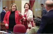  ?? FRED GREAVES / FOR CALMATTERS ?? State Sens. Caroline Menjivar and Toni Atkins talk with other lawmakers during a Senate floor session at the Capitol in Sacramento on Jan. 22.