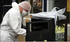  ?? AFP photo ?? A forensics officer looking for evidence in Peel Square. —