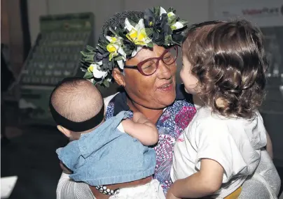  ?? PHOTO: GETTY IMAGES ?? Family ties . . . Virginia Cabral meets her grandchild­ren Maria Virginia (left) and Mahina Franca in the Auckland Airport arrivals lounge yesterday after disembarki­ng from the first quarantine­free flight from Rarotonga, in the Cook Islands, in 10 months.