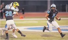  ?? ADOLPHE PIERRELOUI­S /JOURNAL ?? Cleveland running back Dorian Lewis, right, looks for room during the Storm’s win over Mayfield Friday. Lewis rushed for 175 yards and three touchdowns.