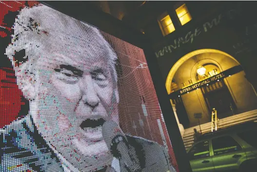  ?? AL DRAGO/BLOOMBERG ?? A vehicle displays an image of U.S. President Donald Trump during the Republican National Convention in Washington on Tuesday, Diane Francis fears that even if Trump accepts defeat in the November election, nothing will protect the public, the economy, the markets and the world from a rogue, lame-duck president until Jan. 20, 2021.