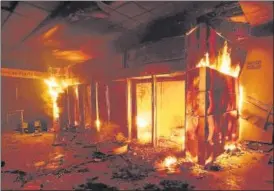  ??  ?? ■ A subway ticket office is seen on fire during a rally against a hike in ticket prices in Santiago, Chile.