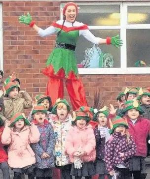  ??  ?? Pupils at Ivy Bank Primary School got into the Elf Run spirit in 2016, with runs across the area raising £47,000. Now schools and groups are being invited to take part in this year event for East Cheshire Hospice