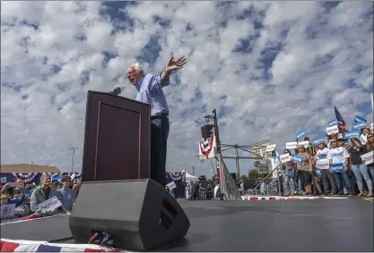  ?? PHOTOS BY DAVID MCNEW — GETTY IMAGES ?? Democratic presidenti­al candidate Sen. Bernie Sanders speaks during a “Get Out the Early Vote” rally on Feb. 21at Valley High School in Santa Ana. Sanders has opened up a strong lead in the state, according to a new poll by UC Berkeley’s Institute of Government­al Studies.