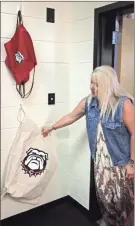  ?? / Kevin Myrick ?? Cedartown Middle School principal Shannon Hulsey shows off bags used by The Dawg House program to provide services, like food help or clean laundry for those in need attending the school.