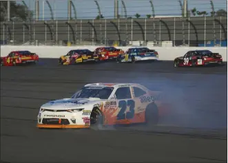  ?? Barry Cantrell ?? NKP Spencer Gallagher, driving a No. 23 Chevrolet, spins in the NASCAR Xfinity Series Powershare­s QQQ
300 at Daytona Internatio­nal Speedway on Saturday. He finished sixth despite hitting an inside wall.